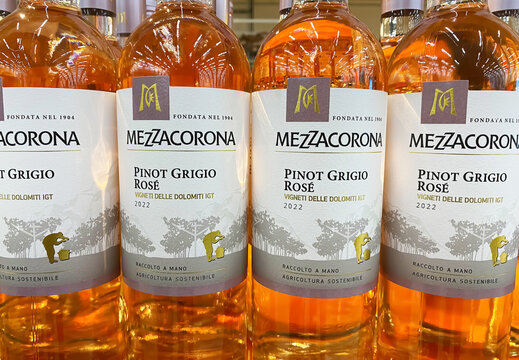 Viersen, Germany - June 9. 2023: Closeup of bottles italian Mezzacorona pinot grigio rose wine from Trentino in store shelf