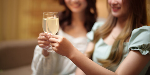 Group of friends celebrating with champagne Close up on hands.