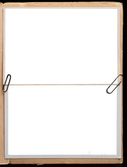 A vintage book page with blank photo frames attached with paper clips. - 624418613