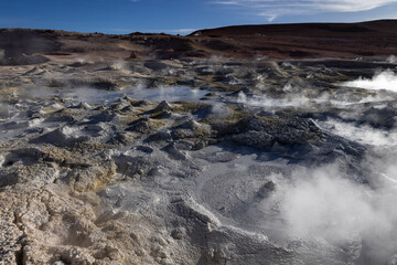 Fototapeta na wymiar Stunning geothermic field of Sol de Mañana with its steaming geysers and hot pools with bubbling mud - just one sight on the lagoon route in Bolivia, South America