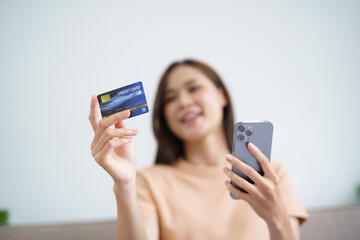 Asian woman with smart phone for online shopping.  Hand holding mobile phone with Payment on credit card online shopping electronic wallet Payment Shopping by phone connected card concept
