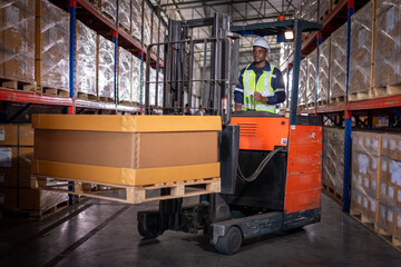 Obraz na płótnie Canvas Africa worker industry factory wear safety uniform factory drive forklift truck moving goods boxes to industry production in factory warehouse area is industry manufacturing transportation concept.