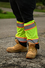 Plakat close up of worker with work boots and reflective safety gaiters