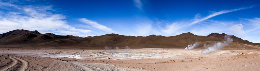 Stunning geothermic field of Sol de Mañana with its steaming geysers and hot pools with bubbling mud - just one sight on the lagoon route in Bolivia, South America - Panorama
