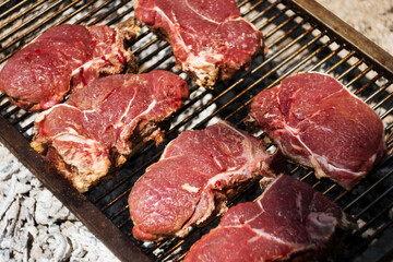 raw Agrentina beef steak bone cooking on bbq  grill