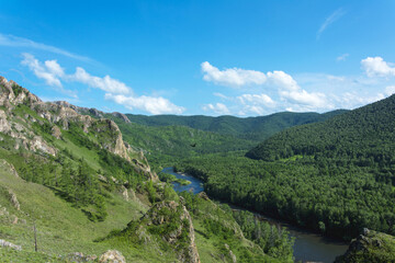 The valley of a small river flowing among the hills overgrown with forest