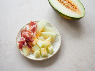 Typical spanish food, melon with ham on a plate. Contrast sweet salty flavor. Starter, appetizer...