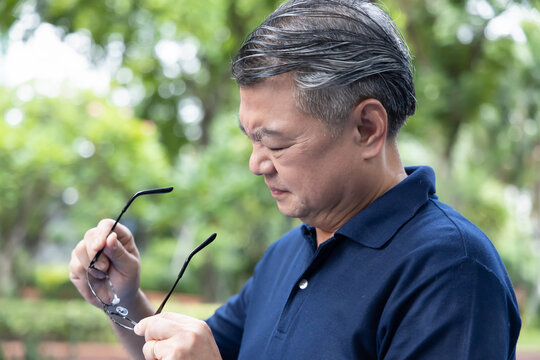 Senior Asian Man Holding Unfit Glasses, Struggling With Eyesight Problem, Eye Health Concept