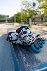 roller skates lie on the sports court in the skate park before the start of the street sports equipment