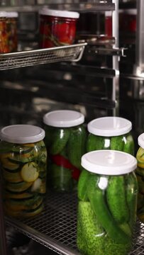 The chef preserves vegetables in the kitchen. Close-up
