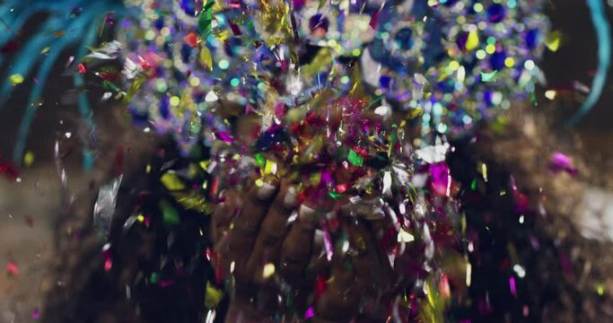 Blowing, confetti and woman at cultural parade, mardi gras or festival for tradition in Brazil. Music, party and female dancer in costume with glitter at street dance event, performance or carnival.