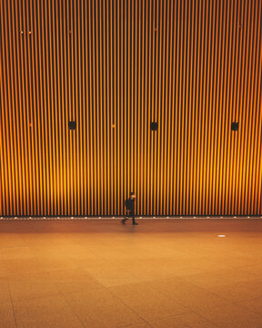 Ginza, Tokyo, Japan - 25 November 2022: View of a man walking in the Tokyo international Forum in Tokyo, Japan.