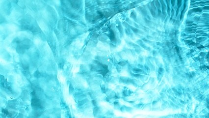 Freeze motion of splashing water surface on light blue background