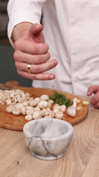 The chef prepares a delicious dish with mushrooms in the kitchen. Close-up