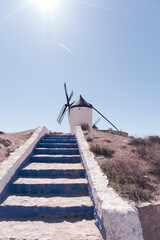 Isolated Don Quixote's windmill of Consuegra from below with blue stairs in Toledo. Representative picture in the area of "La Mancha"