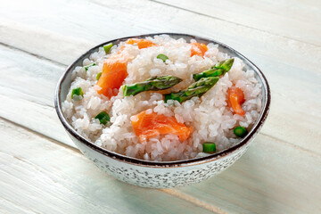 Konjac rice. Shirataki with salmon and asparagus, a healthy diet dish, on a wooden background