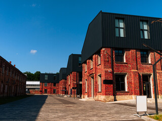 Modern cafe workspace exterior loft style red brick wall Old industrial building renovation. Creative urban space Break-out area city loft conversion brickwork warehouse design floor-to-ceiling window