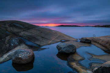 Serene Coastal Dusk: Beauty of Nature Unveiled over Sweden's Reflective Shoreline