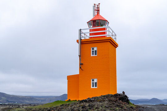 Pretty orange Hopsnes Lighthouse near Grindavik, Iceland on the Reykjanes Peninsula