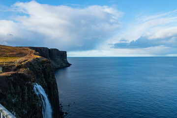 Fototapeta na wymiar Sea view from the cliffs with water fall. Isle of Skye.