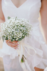 Beautiful wedding bouquet of flowers in a bride hand
