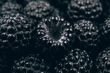 Black raspberries closeup. Macro shot. Heap of fresh ripe and sweet raspberries. 