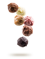 Assorted chocolate pralines floating on white background
