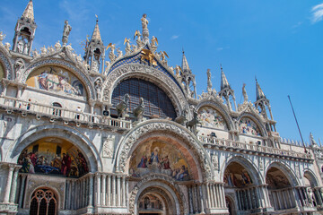 Fototapeta na wymiar Details of St Mark's Basilica or the Basilica di San Marco in Italian, golden mosaics, intricate carvings, and statues adorn the roof of St. Mark's Basilica, a true marvel of Byzantine art in Venice.