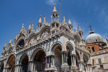 Fototapeta na wymiar Details of St Mark's Basilica or the Basilica di San Marco in Italian, golden mosaics, intricate carvings, and statues adorn the roof of St. Mark's Basilica, a true marvel of Byzantine art in Venice.