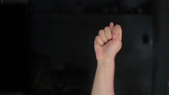 T t alphabet American sign language video demonstration in HD, American Sign Language (ASL) single-handed T t letter sign isolated on black background.
