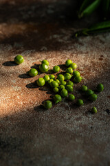 Fresh green peas on stone surface.