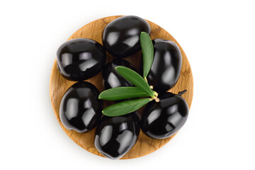 Black olives with leaves in wooden bowl isolated on a white background with full depth of field. Top view. Flat lay