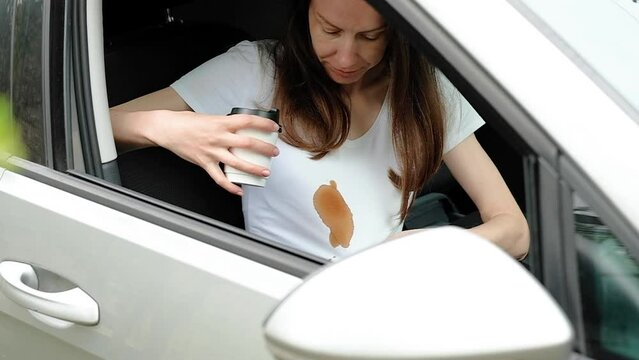 Dirty stain of spilled coffee while driving. woman showing a stain on white clothes. daily life stain concept