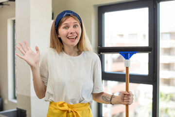 young pretty woman feeling happy and astonished at something unbelievable. windows washer concept