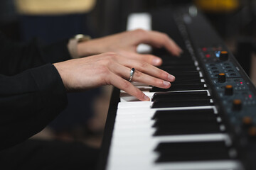 close-up of a pianist's hands while playing the piano