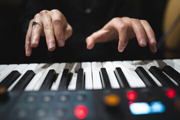 close-up of a pianist's hands while playing the piano