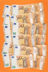 50 euro bills on an orange background