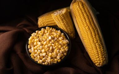 corn seed with corn cobs on a brown fabric, corn creative advertising image