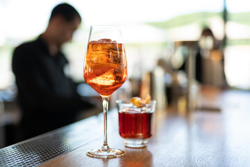 the bartender prepares a beautiful alcoholic cocktail at the bar counter