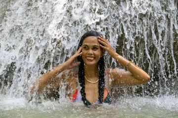 smiling girl in a waterfall