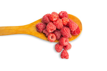 Fresh raspberries in a wooden spoon and scattered next to the spoon on a transparent background.