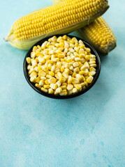 Corn with black bowl isolated on blue colour background