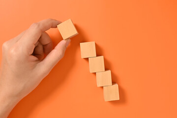 Hand with wooden cubes mock up on abstract background, Copy space, Wooden blocks with copy space for text or symbols, Background with copy space