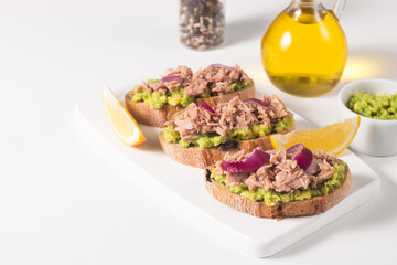 Toast with Canned Tuna. Fish open sandwich with red onion and lemon. 