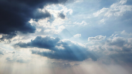 Fototapeta na wymiar Dramatic stormy clouds with light rays shining through