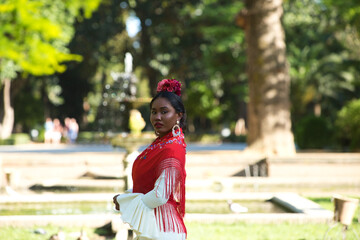 Young black woman dressed as a flamenco dancer stands in a famous park next to a duck pond in...