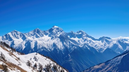 Fototapeta na wymiar Snow-capped mountains against a clear sky