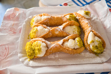Sicilian dessert, cake called cannoli on paper tray