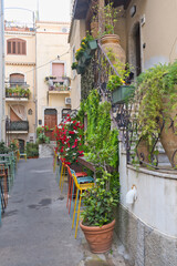 Fototapeta na wymiar Taormina, Italy, Sicily, old town, bars, alleys, old facades, stairs with a Mediterranean flair