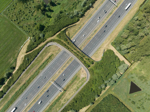 Aerial video of highway with a ecoduct to allow for safe passage of wildlife near Utrecht, The Netherlands.